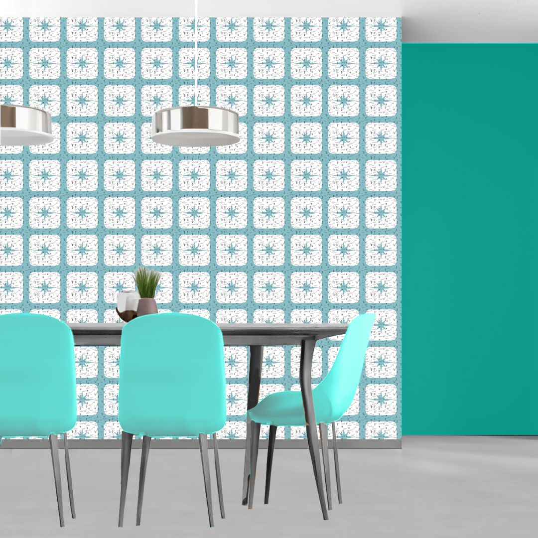 The artwork features a repeating geometric pattern of symmetrical shapes resembling elongated, curved diamonds or petals in various shades of blue and green. Each shape is split vertically with one half filled with a light blue and the other half filled with green or darker blue. The background is a light, almost pastel blue, which provides a soft yet vibrant backdrop. One of the blue shapes near the upper left contains a white starburst element, adding a focal point of brightness to the composition. The overall design conveys a modern, mid-century aesthetic with clean lines and harmonious color contrasts.